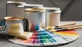 Paint cans, color palette samples and brushes on table Royalty Free Stock Photo