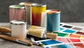 Paint cans, color palette samples and brushes on table Royalty Free Stock Photo