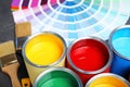 Paint cans and color palette samples on table Royalty Free Stock Photo