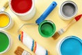 Paint cans with roller and brushes on color background Royalty Free Stock Photo