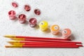 A paint-by-numbers canvas with numbered sections, red-handled paintbrushes, and opened containers of colorful paint
