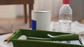 paint roller and bottle of solvent on table