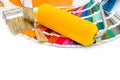 Paint roller with brushes and color swatches book on white background Royalty Free Stock Photo