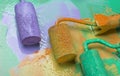 paint roller with green, lilac and orange paint