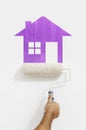 paint roller hand with purple house symbol painting on wall isolated on white