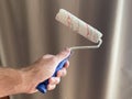 Paint roller in the hands of a man Royalty Free Stock Photo