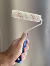 Paint roller in the hands of a man Royalty Free Stock Photo