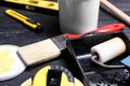 Paint roller in tray and tools on table Royalty Free Stock Photo