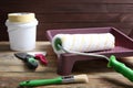 Paint roller in tray and tools on wooden table Royalty Free Stock Photo