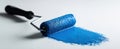 The paint roller with vibrant blue paint on a clean surface AI generated image Royalty Free Stock Photo