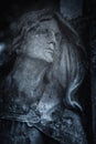 Paint and sorrow concept. Fragment of an ancient stone statue of sad and desperate woman on tomb as a symbol of death and the end