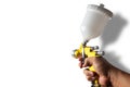 Paint spray of the painter`s arm hand holding industrial size spray gun used for industrial painting and coating and  on Royalty Free Stock Photo