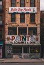 A paint store with graffiti on it, Lower East Side, Manhattan, New York