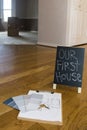 Paint swatches and house plans on floor with first house sign Royalty Free Stock Photo