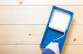 Paint tray with roller on wooden boards Royalty Free Stock Photo