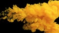 Paint in water on a black background. The ink in the water dissolves. A cloud of acrylic Yellow paint on a black background with a