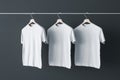 three blank white t-shirts hanging on plain dark wall. Mockup. 3D rendering