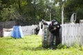 Paintball game on the training ground. Sports combat with paint guns.