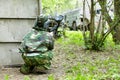 Paintball player in camouflage hides
