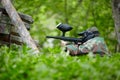 Paintball player in camouflage sits in ambush Royalty Free Stock Photo