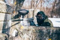 Paintball player shooting at enemy, paintballing Royalty Free Stock Photo