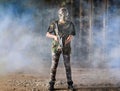 Paintball player in protective camouflage uniform