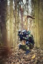 Paintball player in protective uniform and mask aiming gun in th Royalty Free Stock Photo