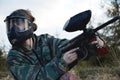 Paintball sport player girl in protective camouflage uniform and mask Royalty Free Stock Photo