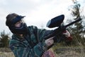 Paintball sport player girl in protective camouflage uniform and mask Royalty Free Stock Photo