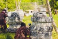 Paintball sport player in protective uniform and mask playing with gun outdoors. Royalty Free Stock Photo