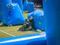 paintball sport player in protective uniform and mask playing with gun outdoors Royalty Free Stock Photo