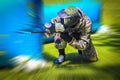 paintball sport player in protective uniform and mask playing with gun outdoors with motion blur effect Royalty Free Stock Photo