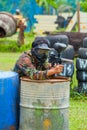 Paintball sport player in protective uniform and mask playing wi Royalty Free Stock Photo