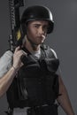 Paintball sport player wearing protective helmet aiming pistol ,