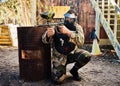 Paintball, target training or male with gun in shooting game playing with on fun battlefield mission. Aim or focused man