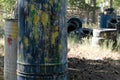 Paintball territory. Close-up of barrels of color blots from paintball gun shots. Old tires from the car as a shelter. Background