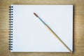 Paintbrush on blank drawing paper book