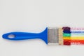 Paintbrush with blue handle and rainbow brush strokes Royalty Free Stock Photo