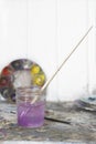 Paintbrush In Jar Of Purple Water