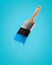 Paintbrush loaded with blue sky color dripping off the bristles.