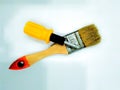 A paintbrush and a minuscule screwdriver that are easy to use everyday