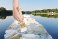 Paintbrush paints ice blocks in lake in summer