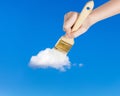 Paintbrush paints lonely white little cloud Royalty Free Stock Photo