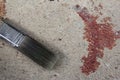 Paintbrush put on grunge cement floor