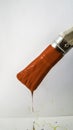 paintbrush with red paint dripping on white background Royalty Free Stock Photo