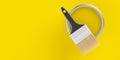 Paintbrush on top of silver paint bucket with yellow paint on yellow background, home renovation concept flat lay top view from