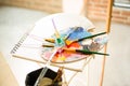 Paintbrushes on artist canvas covered with oil paint with palette closeup Royalty Free Stock Photo