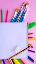 Paintbrushes, the colorful pencils, markers and the eraser under the painting journal Royalty Free Stock Photo