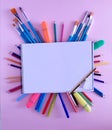 Paintbrushes, the colorful pencils, markers and the eraser under the painting journal Royalty Free Stock Photo