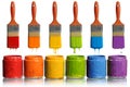 Paintbrushes Dripping into Paint Containers Royalty Free Stock Photo